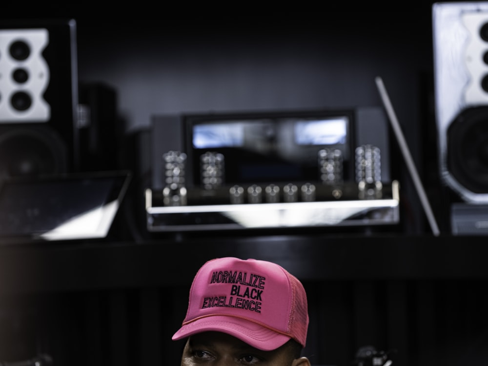 man in red fitted cap and red baseball cap