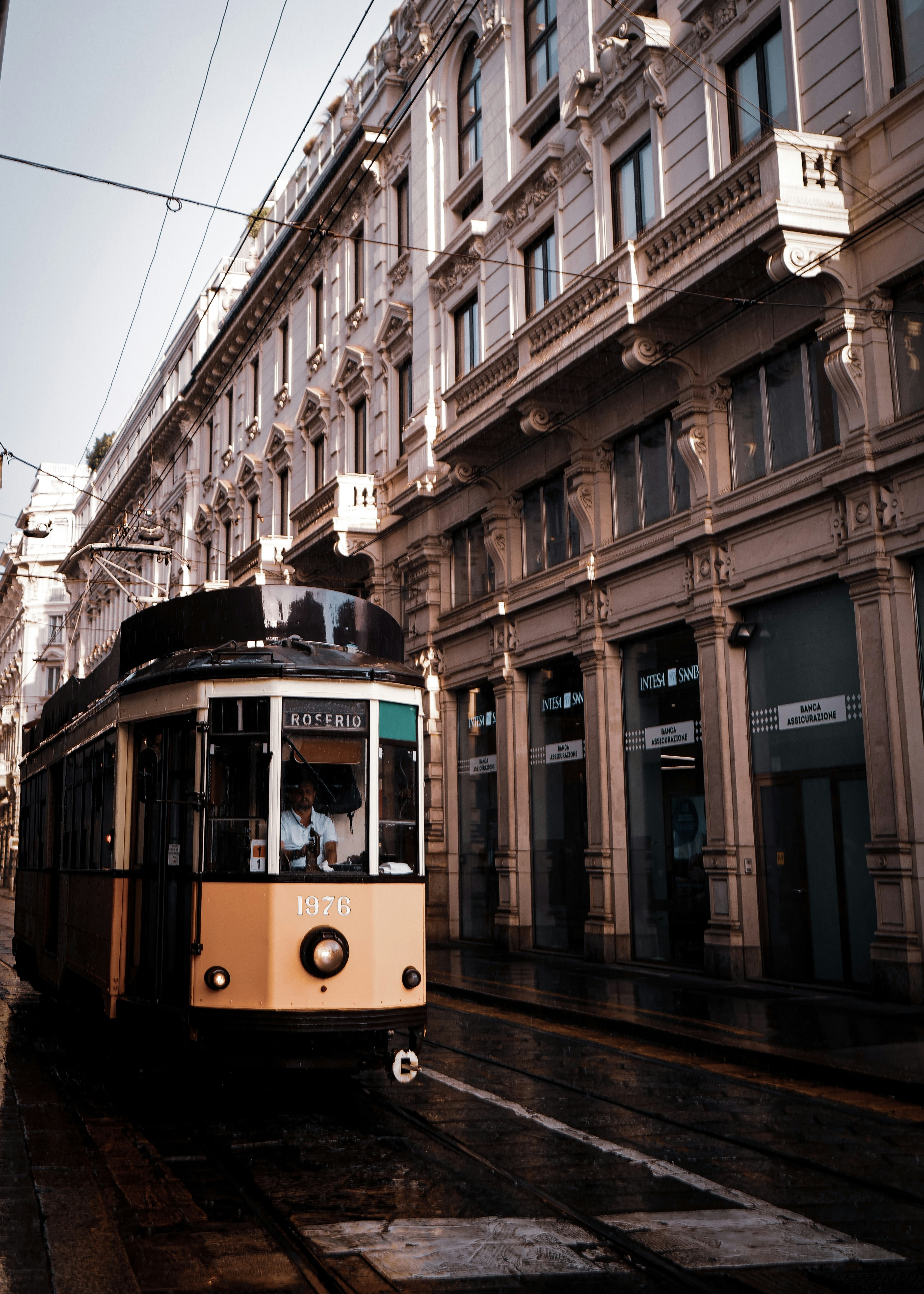 yellow and white tram on road near building during daytime