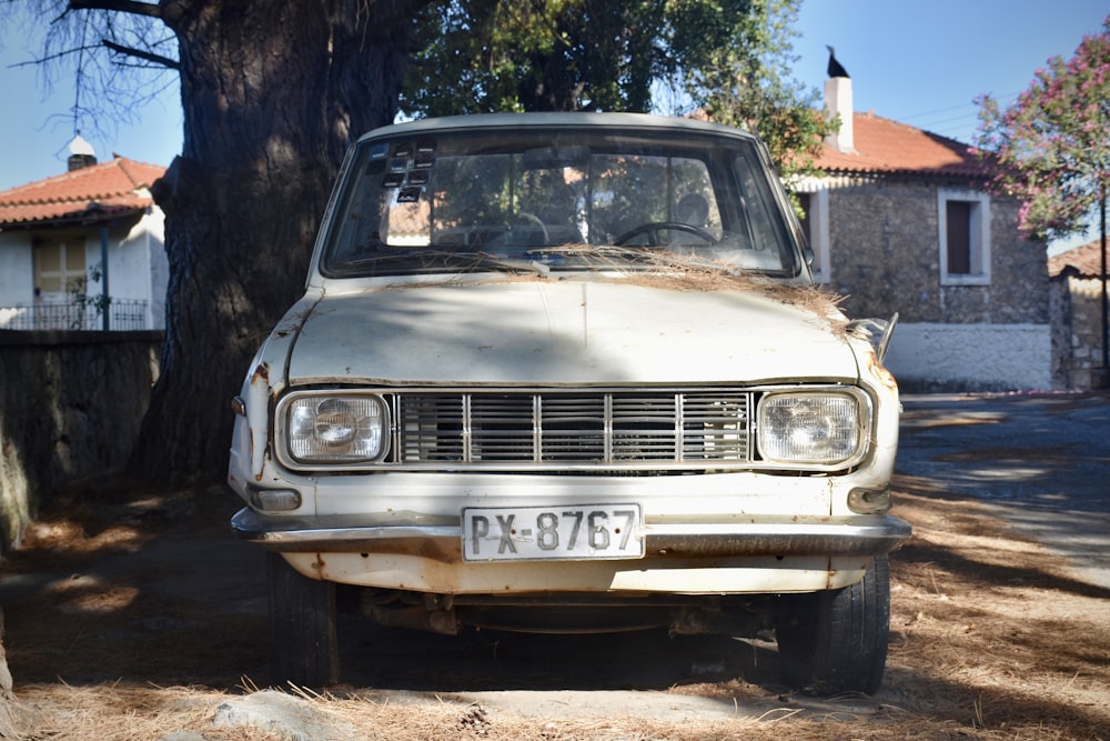 grey car parked near brown concrete building during daytime