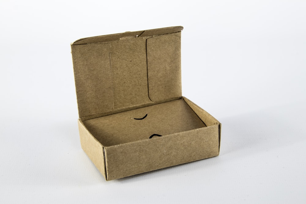 brown cardboard box on white surface