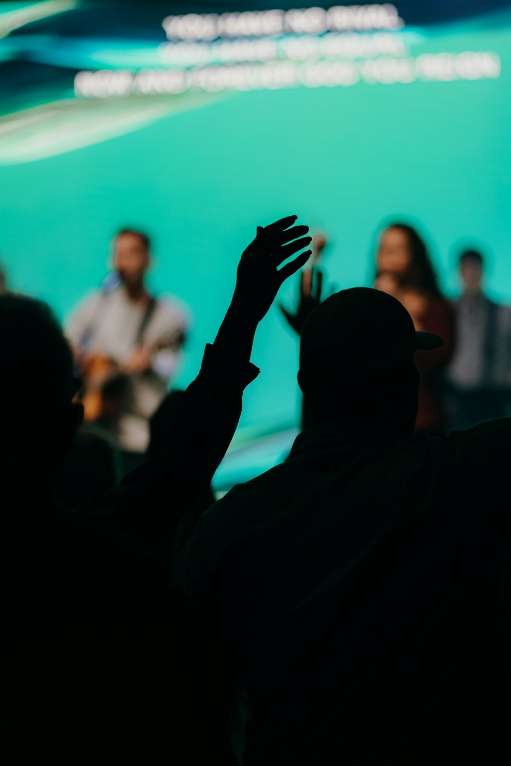 silhouette of man raising his hands