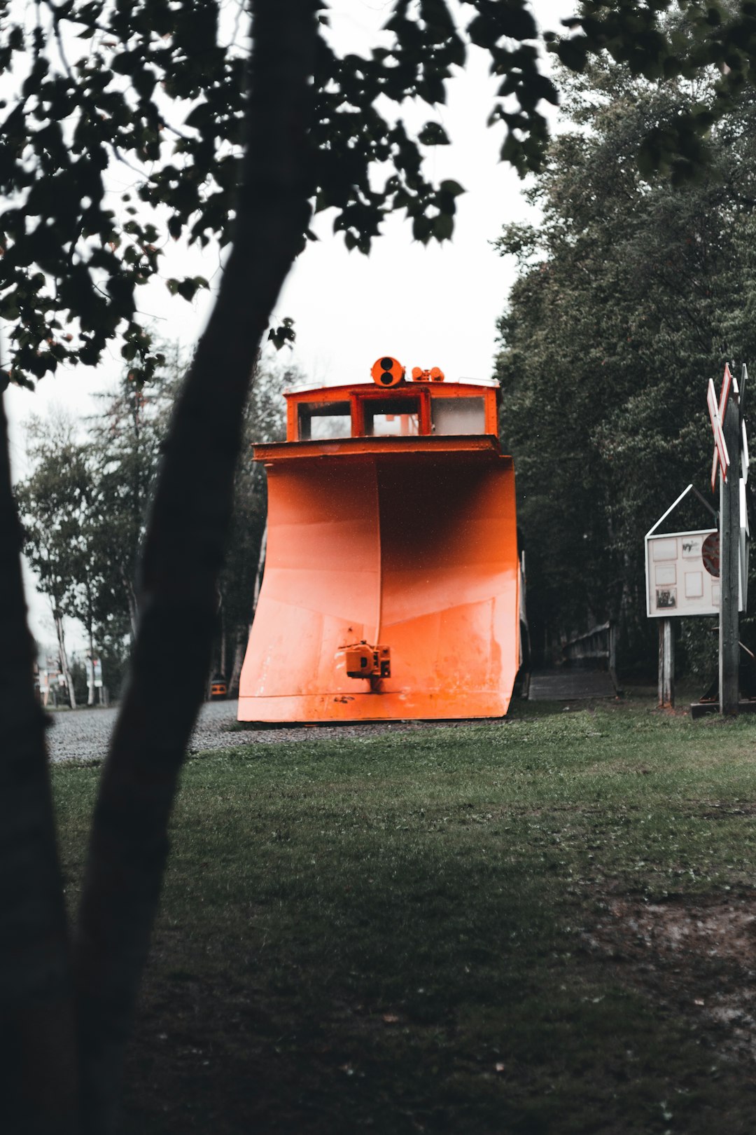 orange and white traffic cone on green grass field