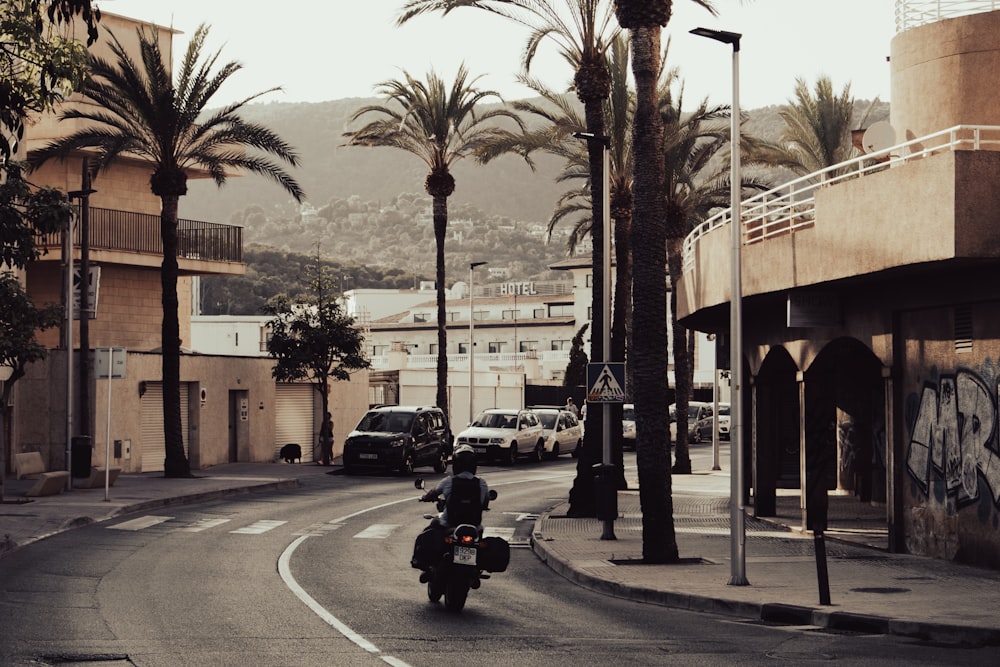 man riding motorcycle on road during daytime