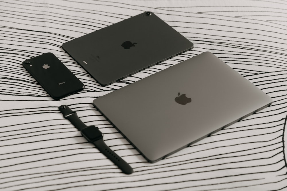silver ipad beside black pen