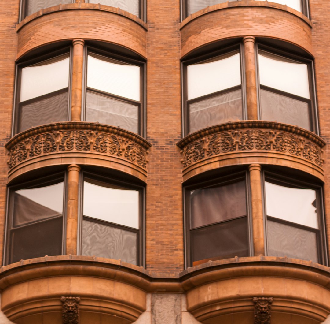 brown concrete building with glass windows