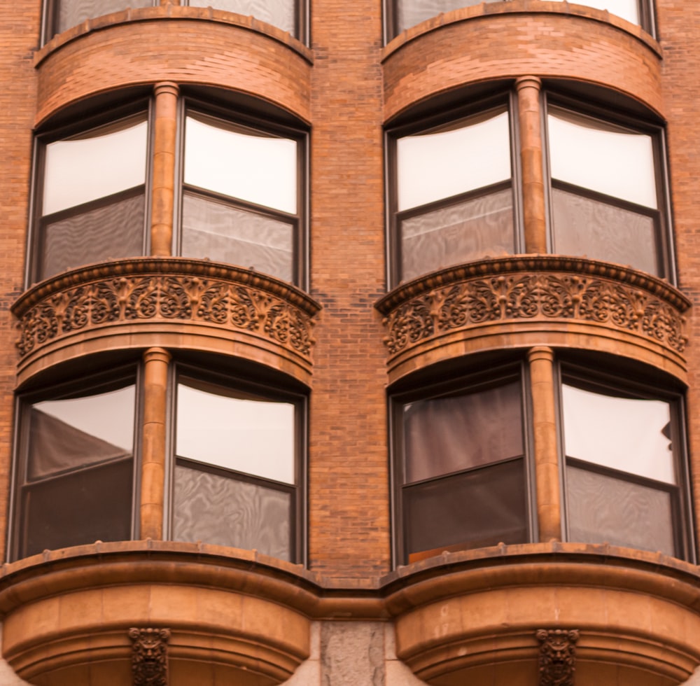 brown concrete building with glass windows