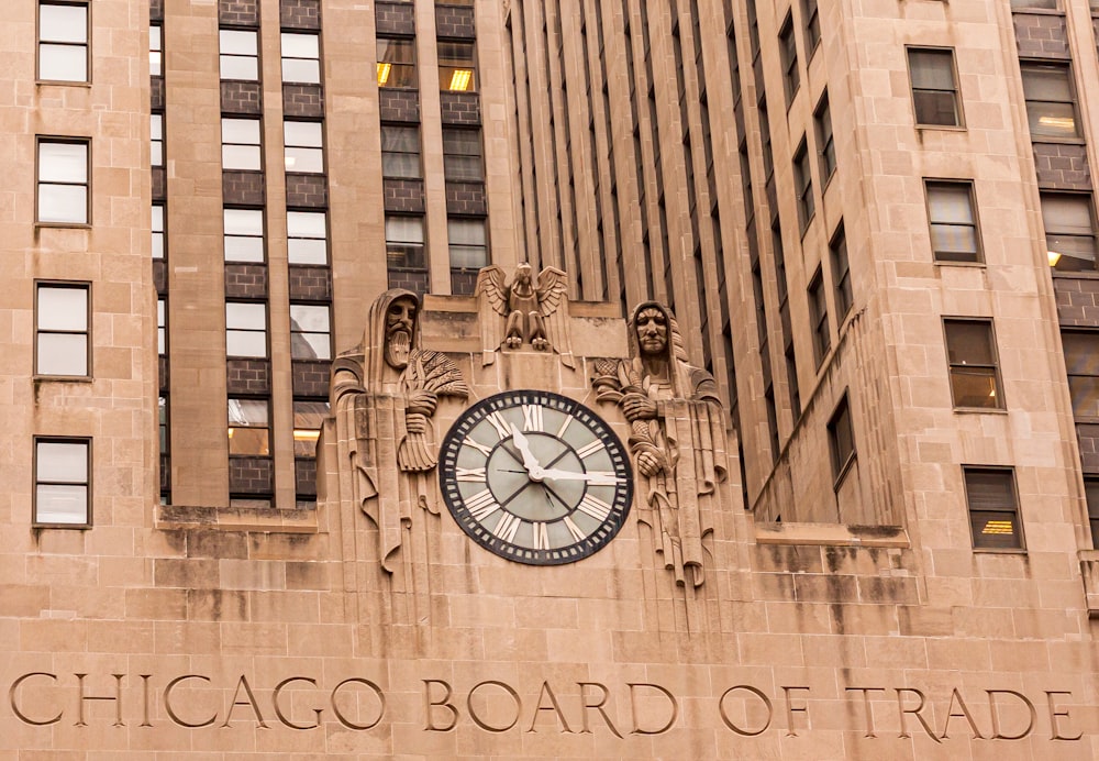 brown concrete building with analog clock