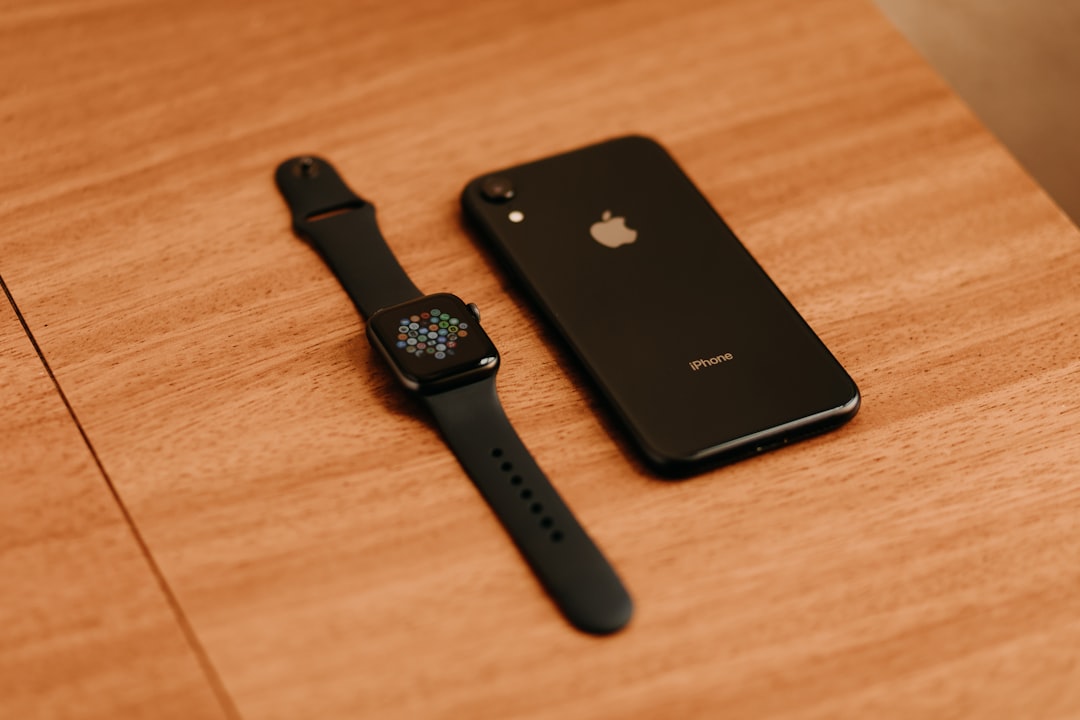 black apple watch on brown wooden table