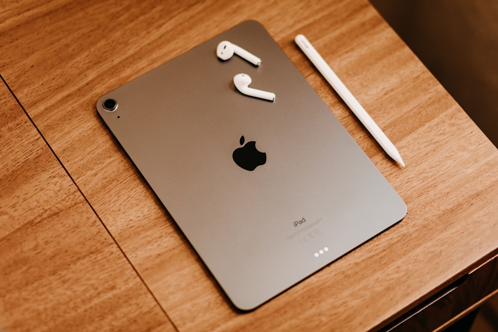 silver ipad on brown wooden table