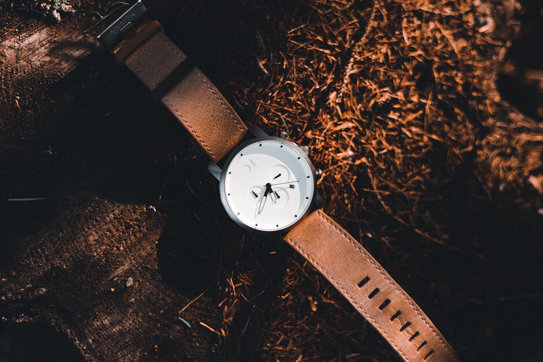black leather strap silver round analog watch