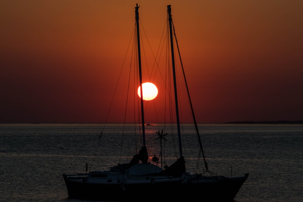 silhouette of person on boat during sunset