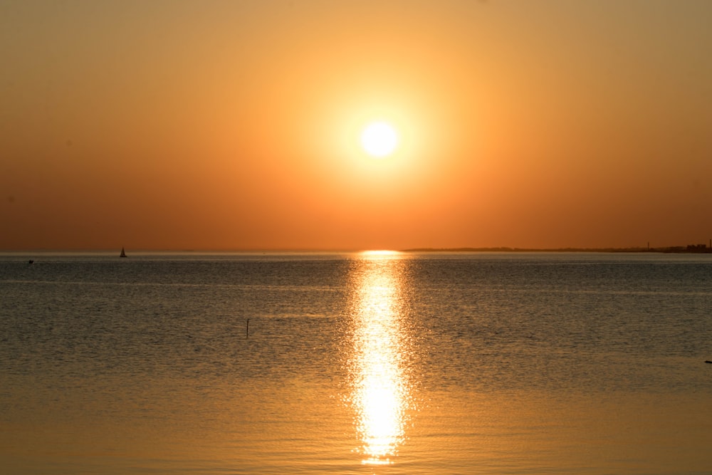 body of water during sunset