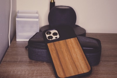 A beautiful and stylish mobile phone case displayed on a wooden surface.