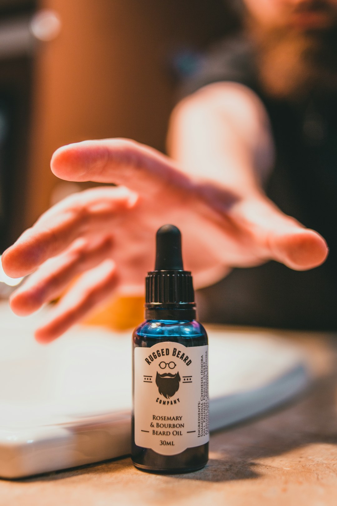 person holding white and black labeled bottle