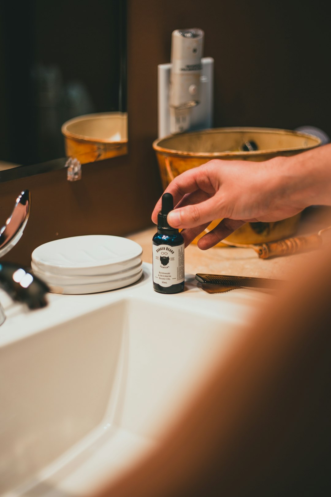 person holding white and black plastic bottle