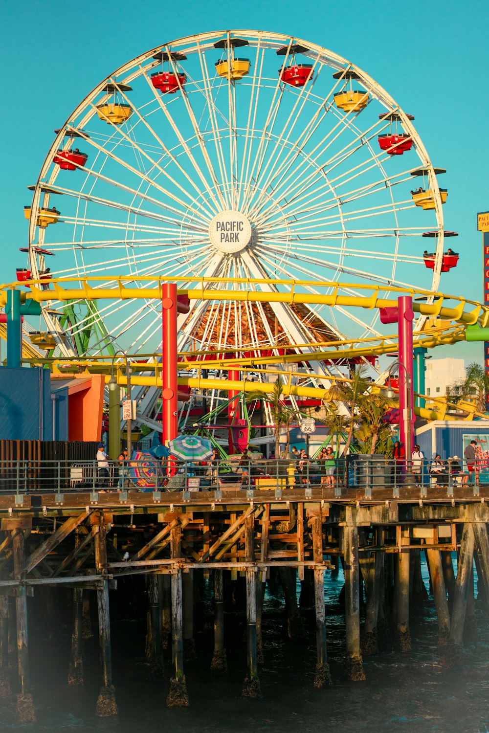 ferris wheel near blue building during daytime