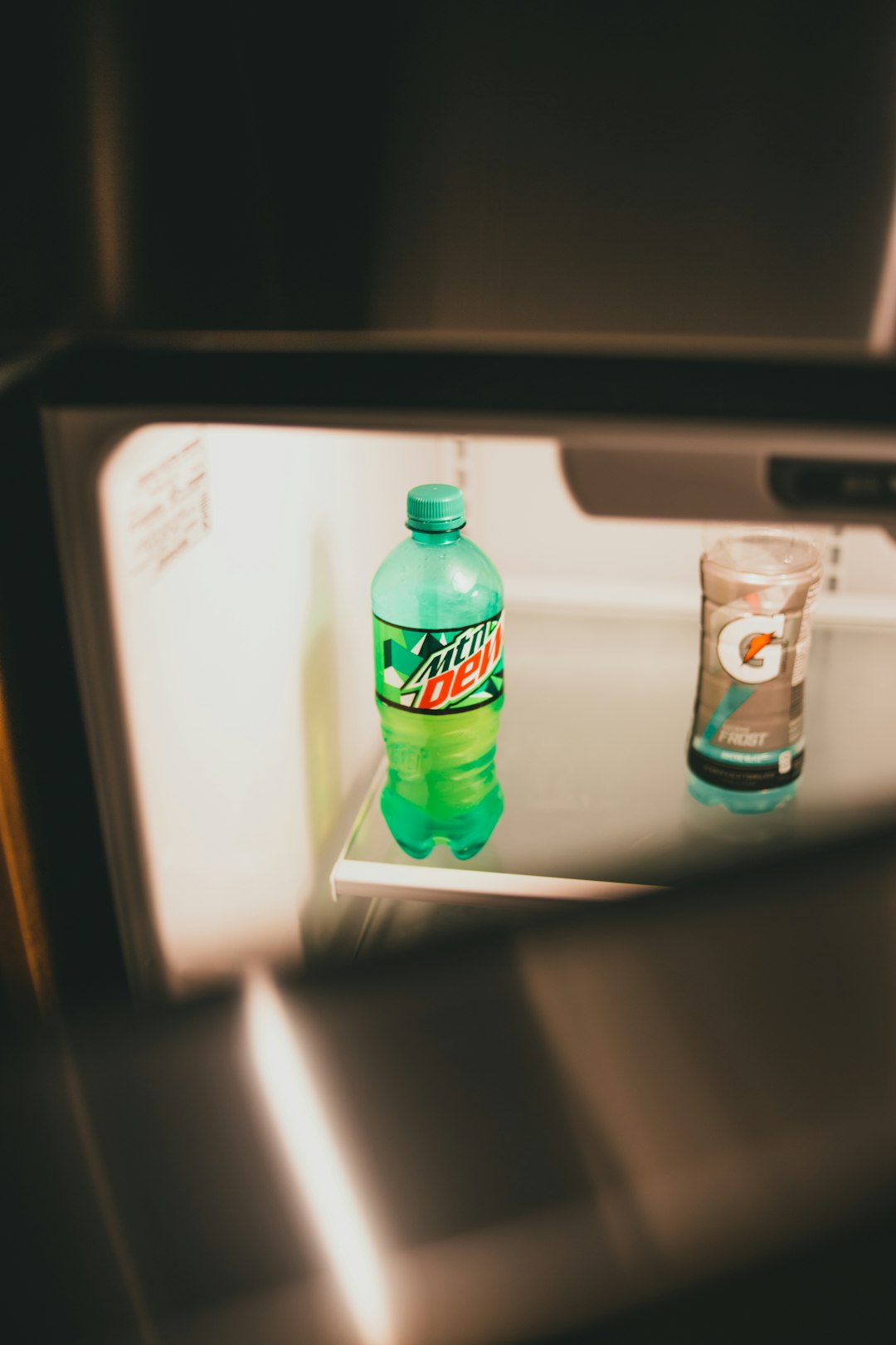 green plastic bottle on refrigerator