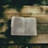 A serene image of an open Bible bathed in soft natural light with greenery in the background.