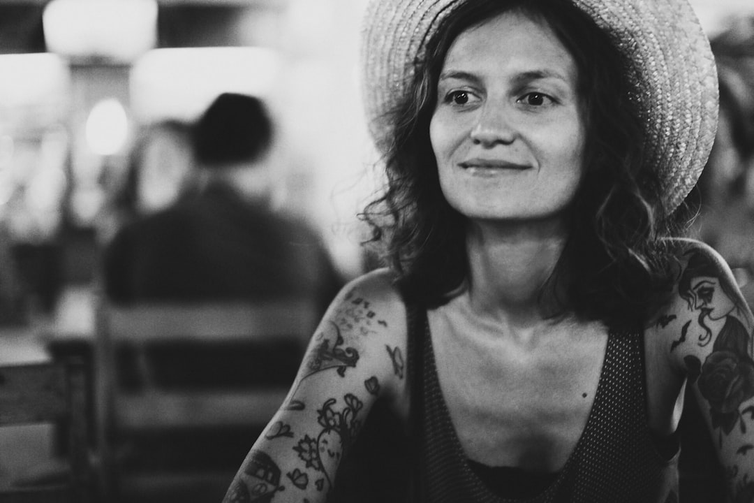 grayscale photo of woman in tank top and hat