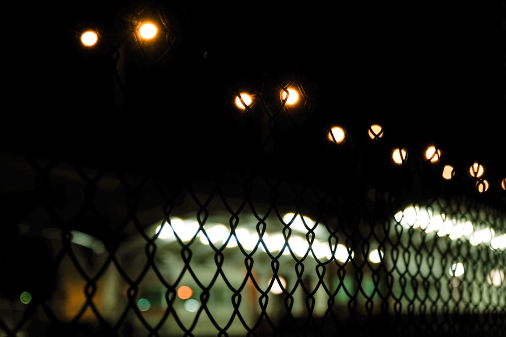 black metal fence with lights during night time