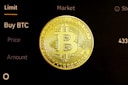 gold round coin on black surface