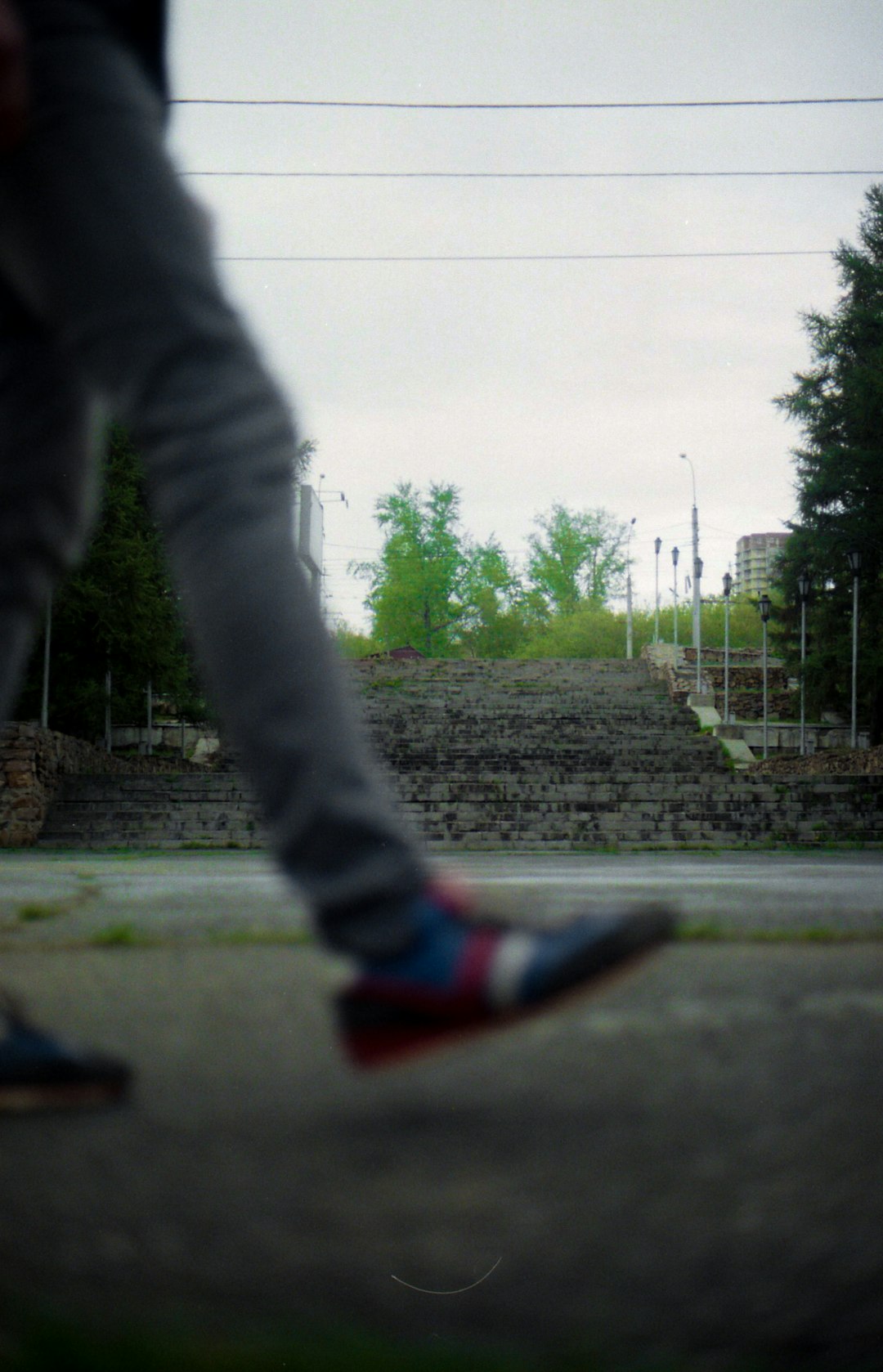 person in gray pants and red and white sneakers