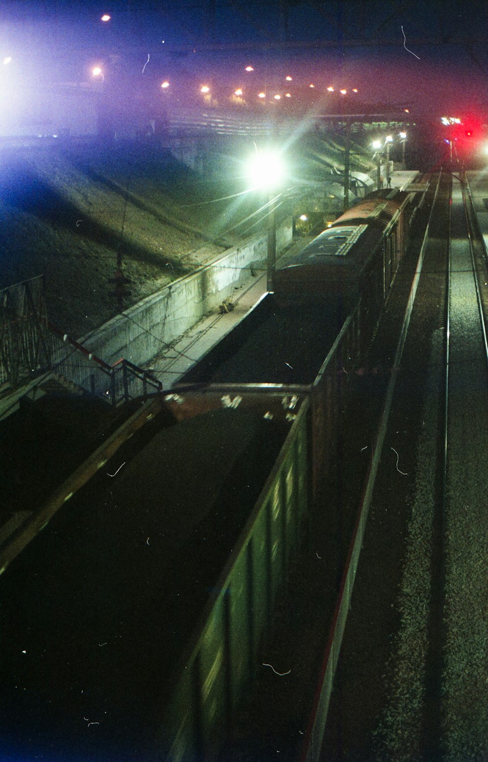 black metal railings near road during night time