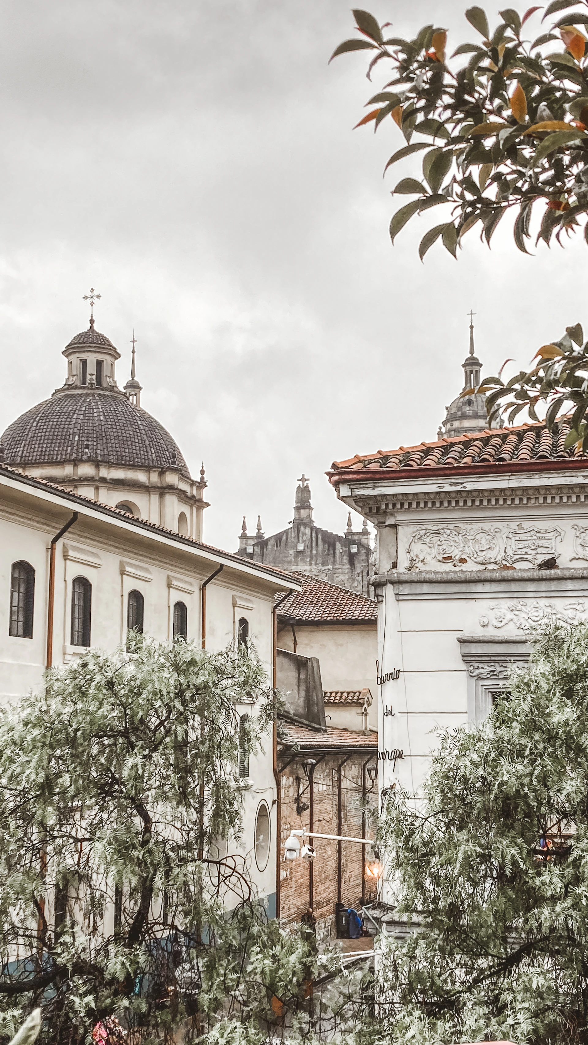 A vintage sepia-toned image of a historic Turkish cityscape blending Ottoman and early Republican era buildings under a moody sky.