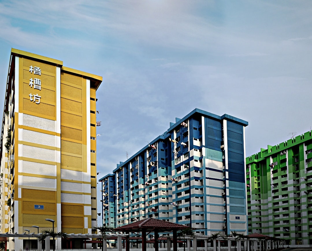 white and brown concrete building under white clouds during daytime