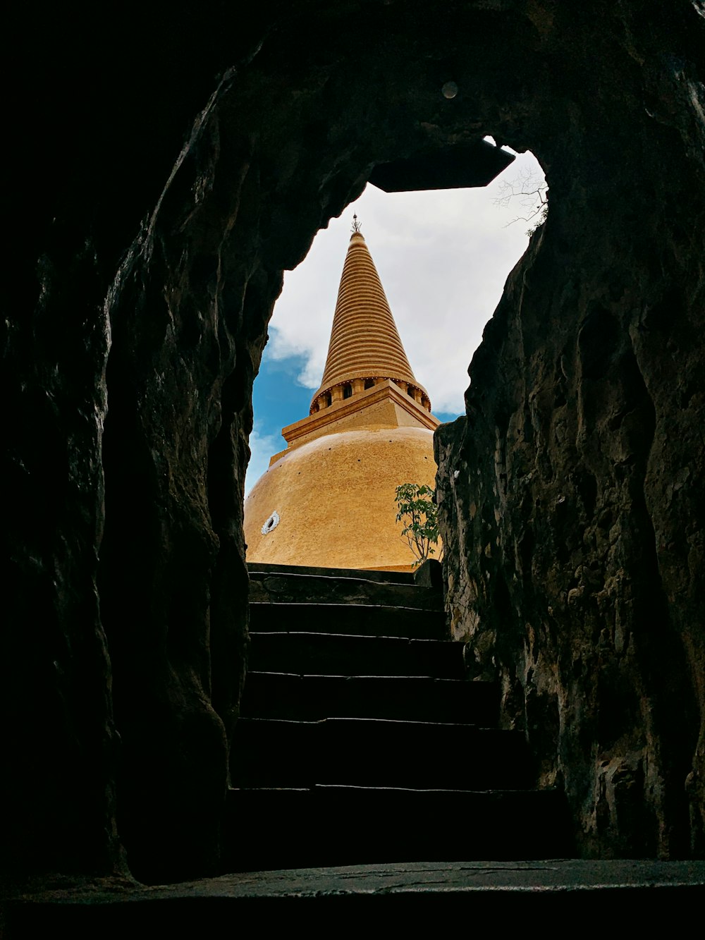 brown concrete staircase between rock formation during daytime