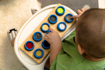A dedicated therapist gently engaging with a child during a playful learning activity.