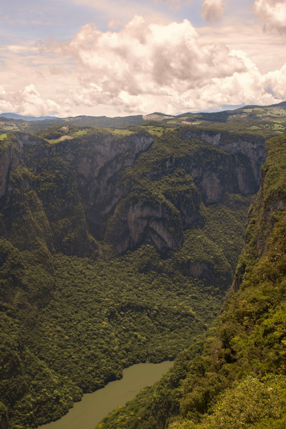 green and brown mountain under white clouds during daytime