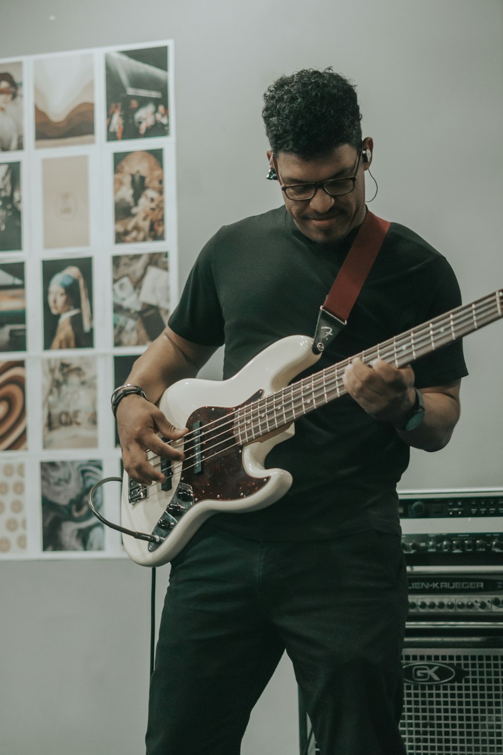 man in black crew neck t-shirt playing white electric guitar