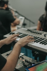 person playing black and white electric piano