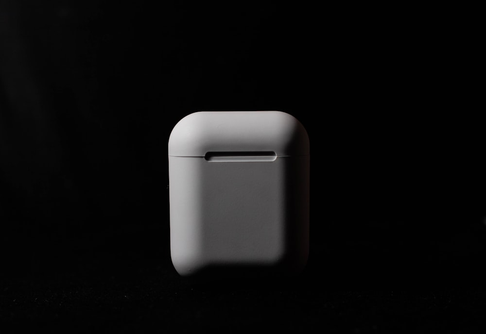 white plastic container on black background