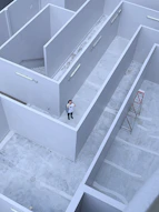 man in white shirt and black pants standing on white staircase