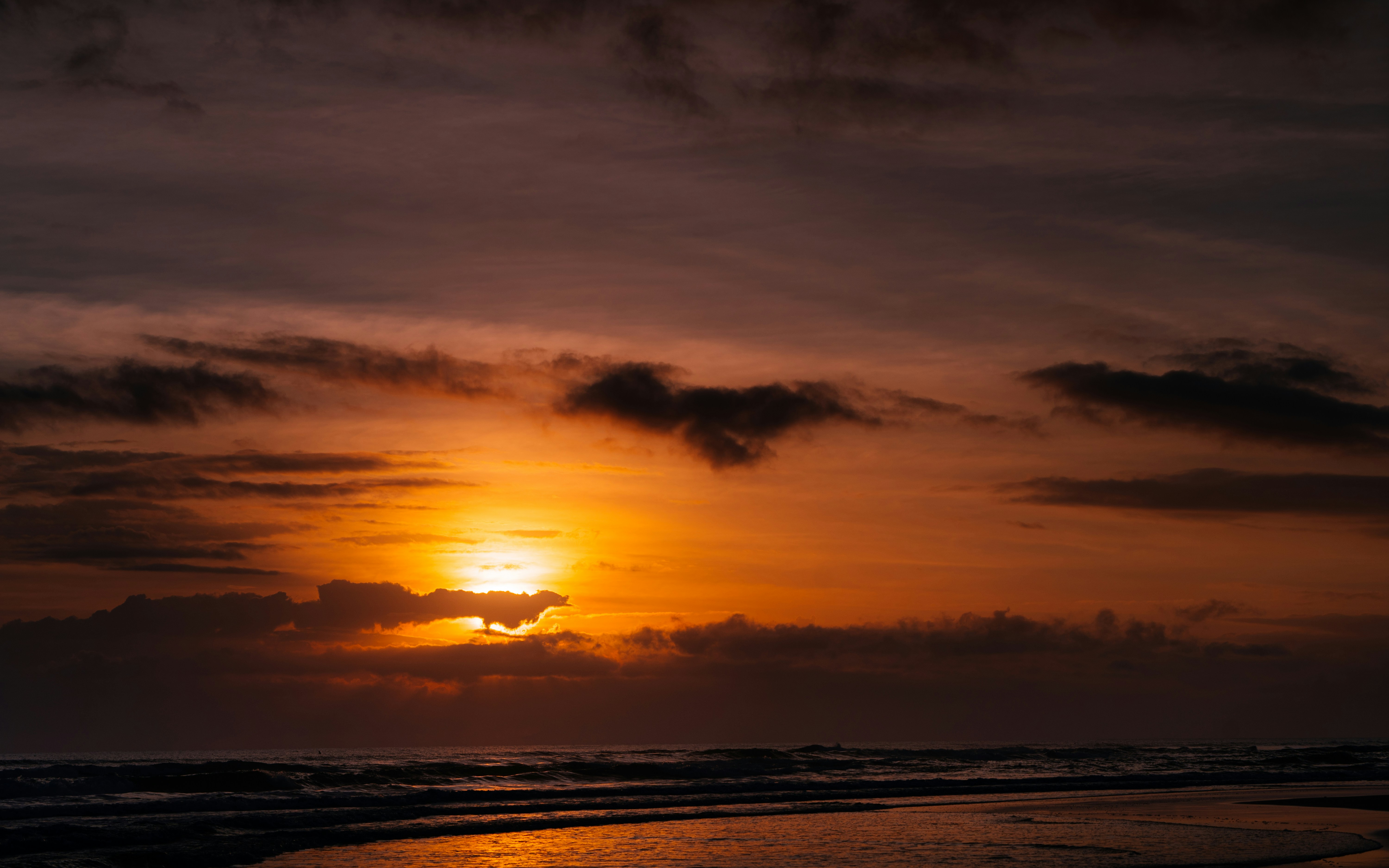 body of water during sunset