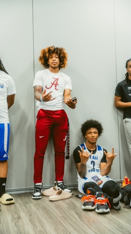 Two young men wearing retro football jerseys: one in a classic Argentina shirt with Nike pants, the other in a vintage Boca Juniors jersey paired with retro Adidas pants, standing side by side in an urban setting.