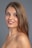 A smiling woman with healthy skin and a vibrant appearance.