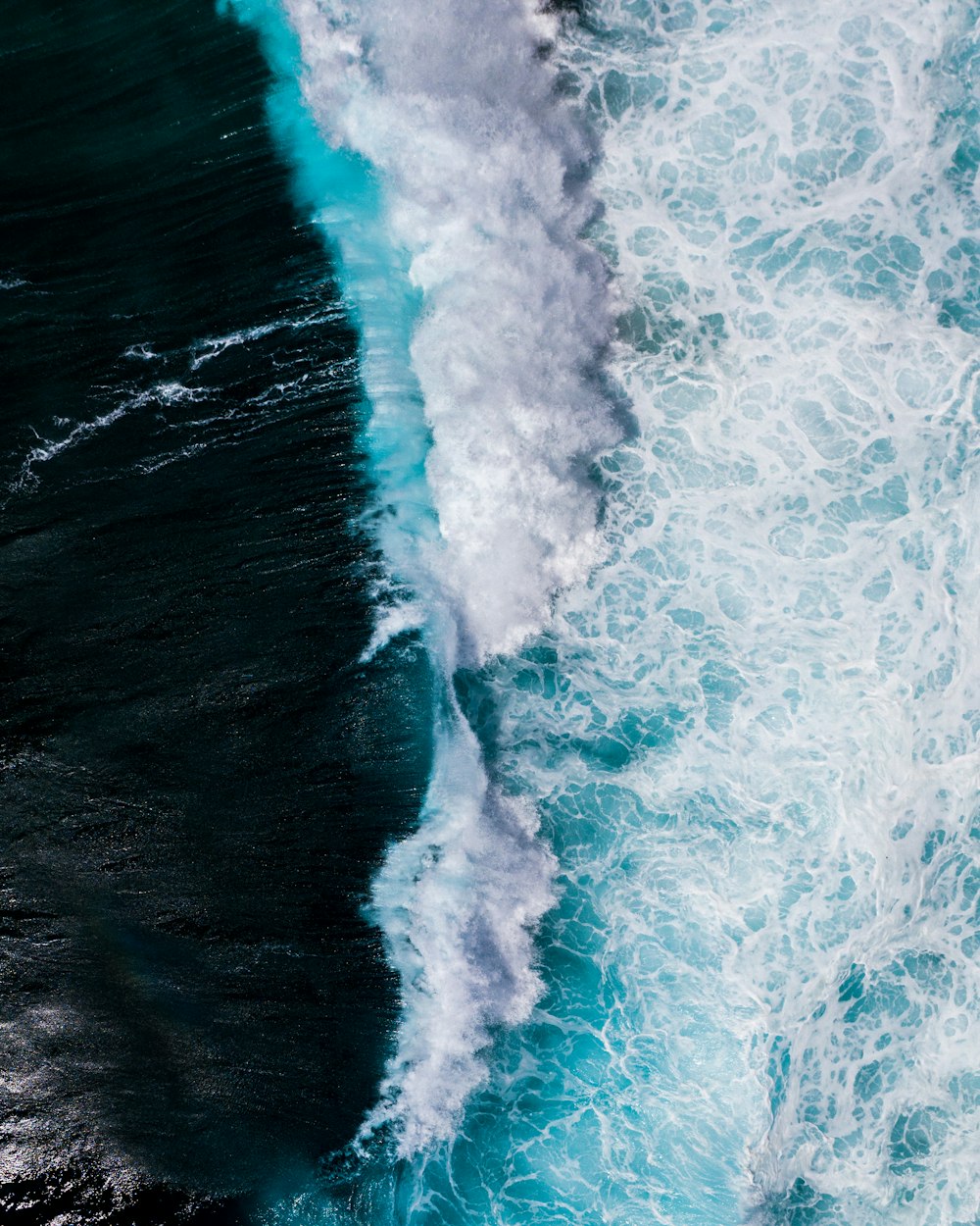 ocean waves crashing on shore during daytime