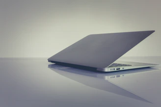 A sleek refurbished laptop open on a modern desk with soft lighting highlighting its premium build.