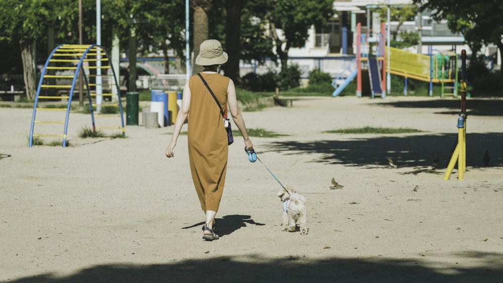 woman in brown dress walking on the street during daytime