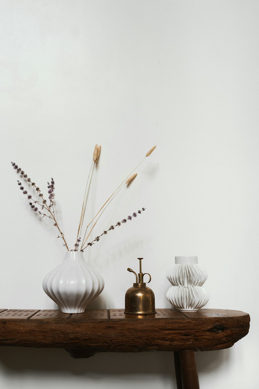 white ceramic vase with brown wooden sticks