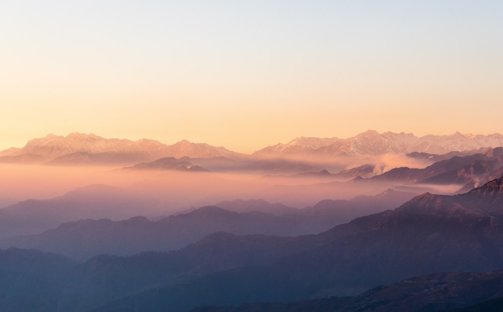 mountains under white clouds during daytime