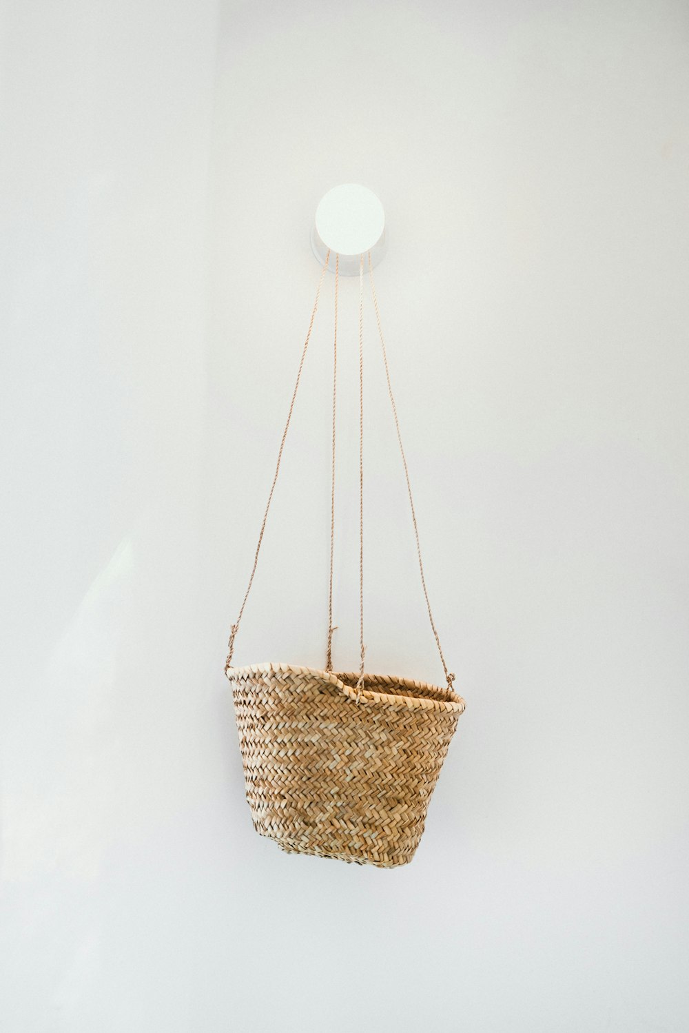 brown wicker basket on white wall