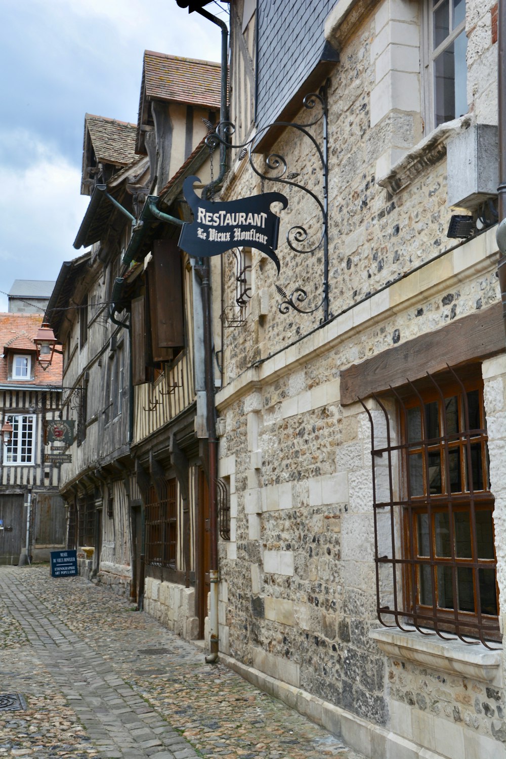 a cobblestone street lined with old buildings