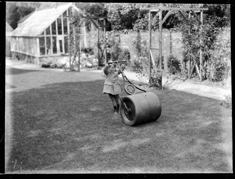 grayscale photo of woman in dress riding motorcycle