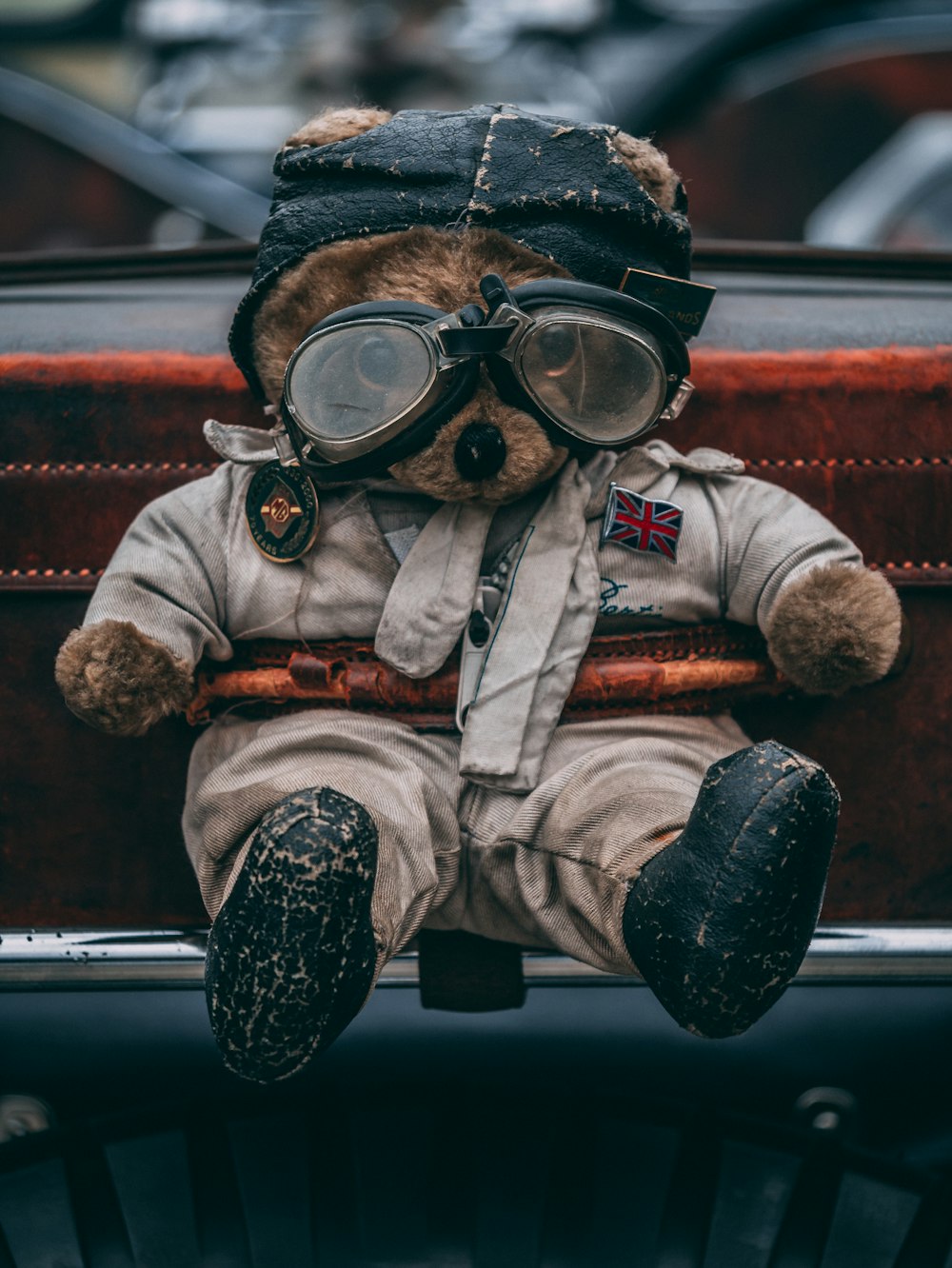 man in brown and white bear costume sitting on red car