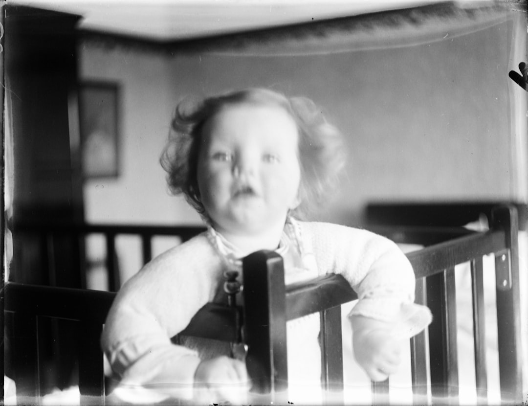  girl in white t shirt sitting on chair bedstead bunk cot