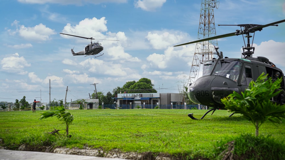 black helicopter on green grass field during daytime